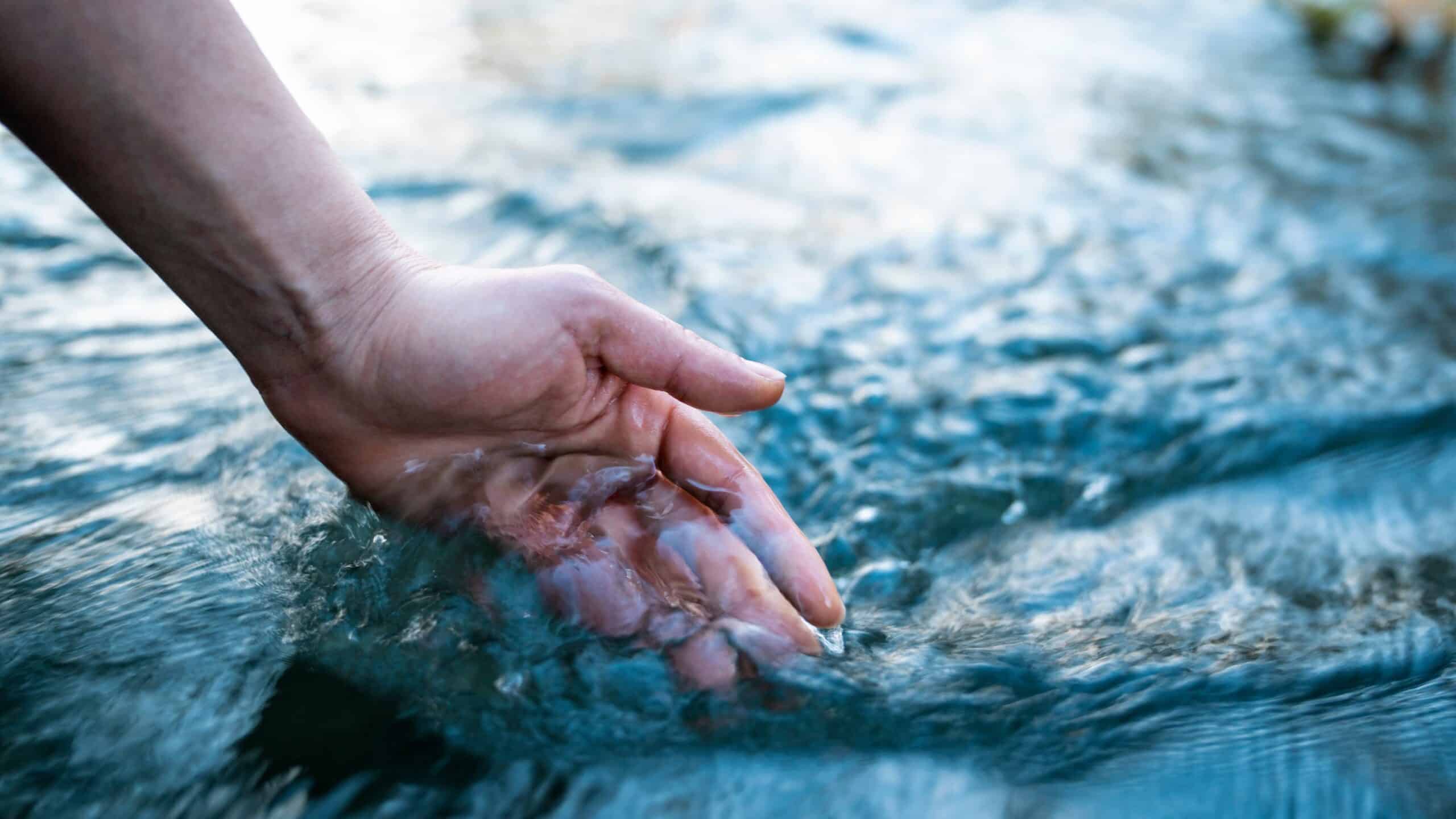 A,Female,Hand,Touching,The,River,Water